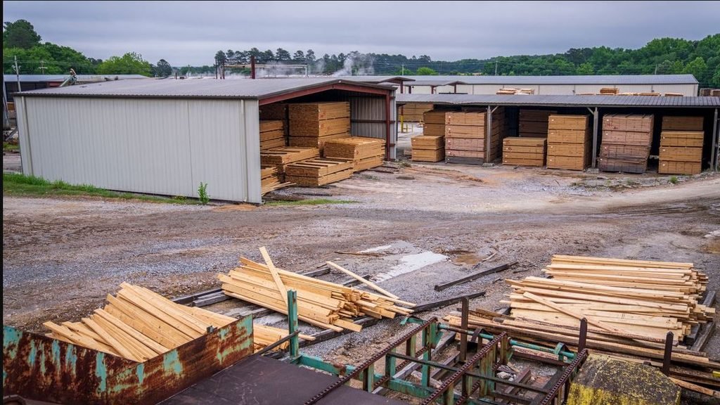 Commercial timber yard with stacked sawn timber and active processing areas