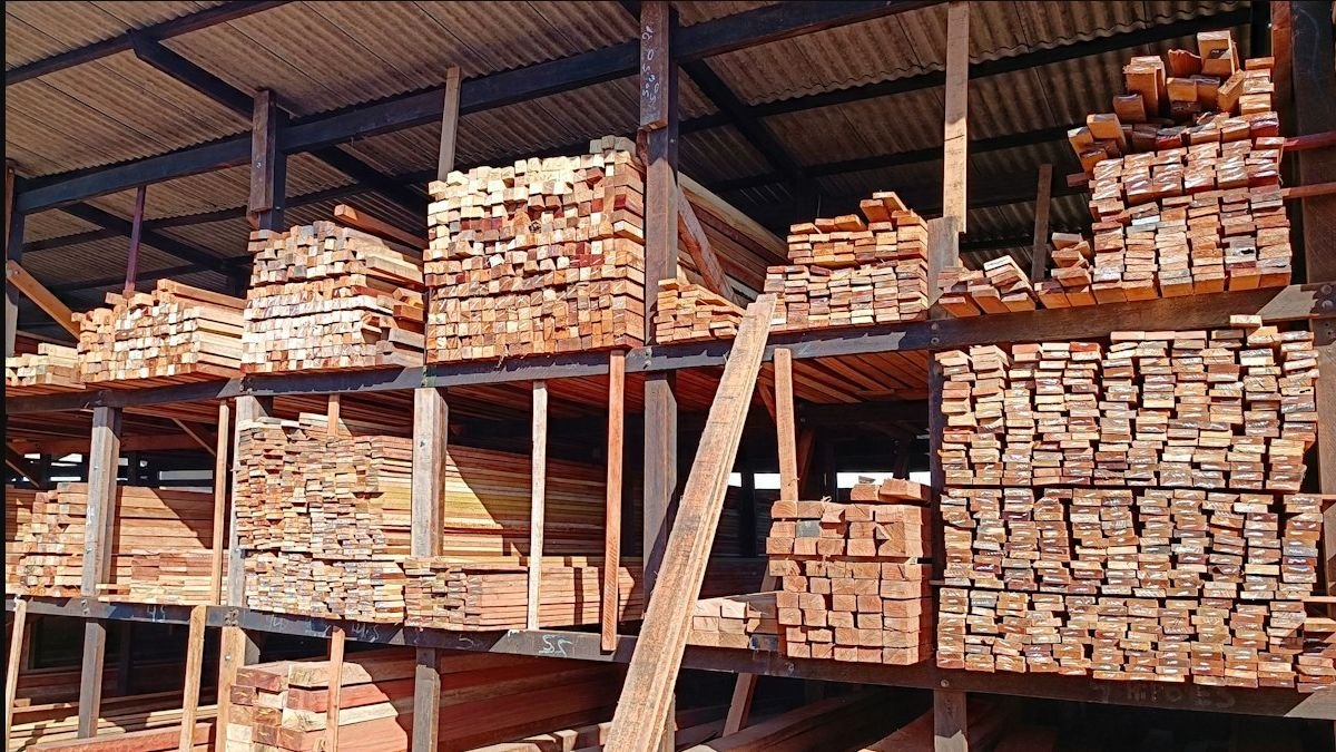 Dry sawn timber boards stacked under cover in a commercial warehouse