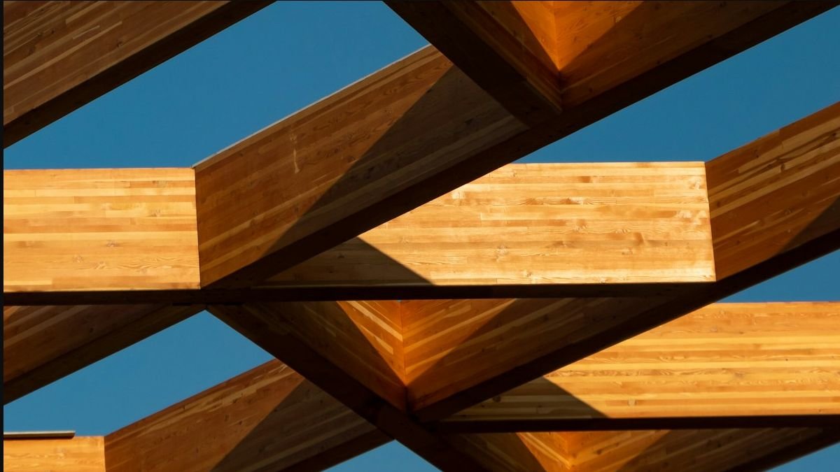 Structural timber beams against a clear sky