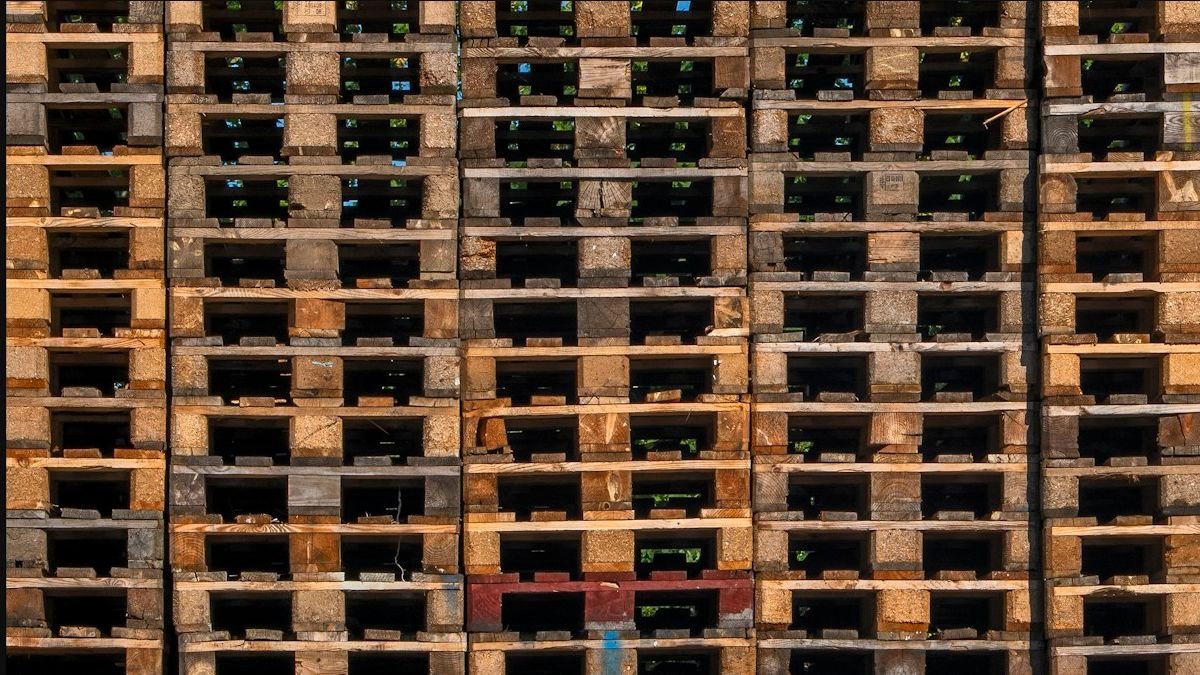 Large stacks of reusable wooden pallets